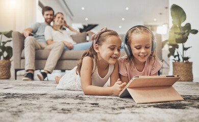 Happy parents, siblings and children with tablet on floor in living room for entertainment together...
