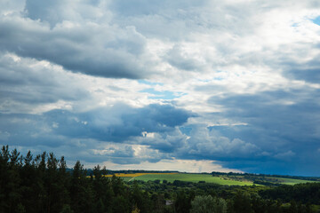 Landscape image of countryside of Ukraine. Cloudy sky, grassy fields and rolling hills rural scenery