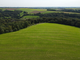 View from above of a countryside with grass, trees and agricultural fields 