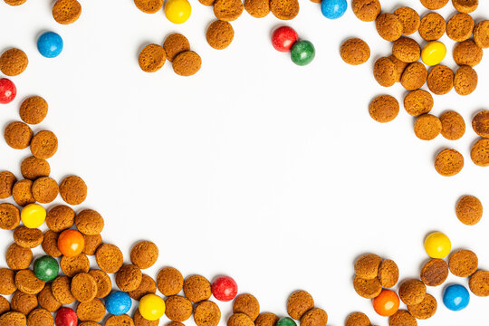 Dutch winter holiday Sinterklaas sweets and cookies strooigoed frame background. Saint Nicholas greeting card celebrating in Netherlands, Belgium, Luxembourg in first week of December. Top view