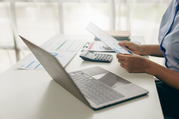 Auditor and accountant working in office Analyze financial data and accounting records with a calculator. Accounting companies provide financial and tax planning services. Close-up pictures - obrazy, fototapety, plakaty