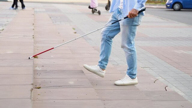 Well Dressed Blind Man Walking Near a Curb with a Long White Cane, Close up on Cane and Feet