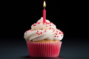 delicious cupcake with sprinkles and a candle on a black background