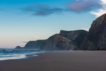 Sunset at sandy Cordoama Beach at Atlantic Ocean, Algarve, Portugal