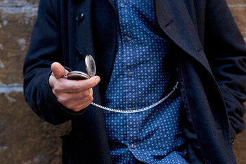 Close up of man looking his pocket watch