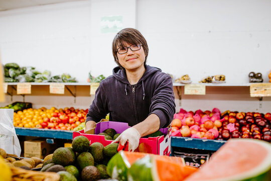 Chinese man working in fruit supermarket