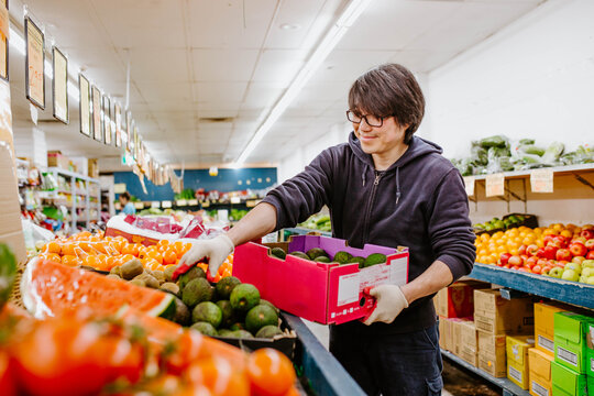 Chinese man working in fruit supermarket