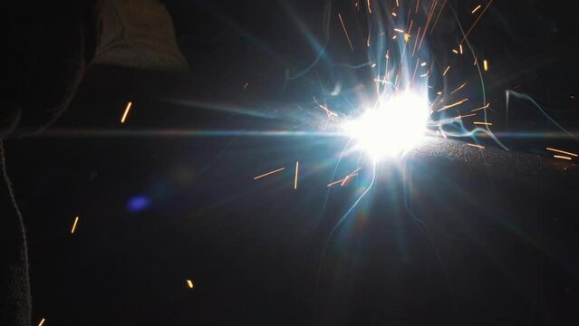 This stock video shows fire, smoke and sparks flying in different directions from the welding machine. This video will decorate your projects related to welders, working specialties, metalworking, ind