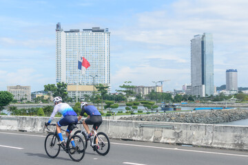 A pair of unrecognizable cyclists enjoying a sunny sunday ride  in Panamá