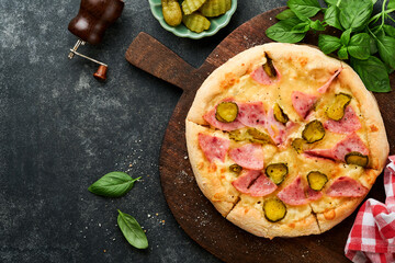 Pizza. Traditional Bacon pizza with ham, mushrooms, pickled cucumber and cheese and cooking...
