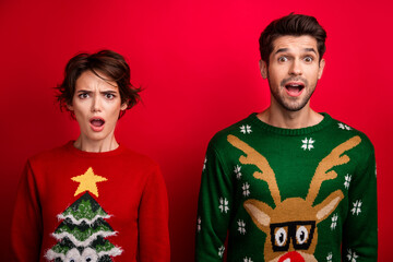 Photo of shocked impressed married couple wear ornament sweaters open mouth isolated red color...