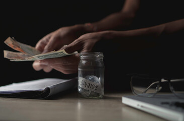 money saving business On a table in dark room. Money Saving Ideas for Financial Accounting