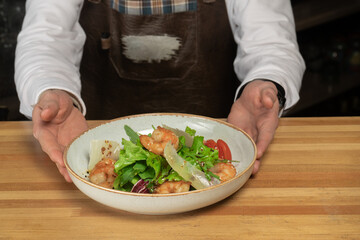 shrimp salad on plates with man's hands