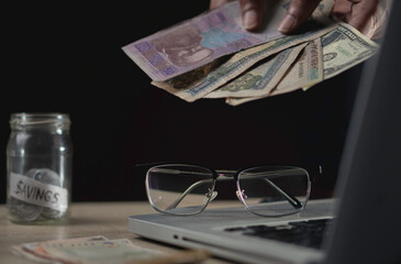 money saving business On a table in dark room. Money Saving Ideas for Financial Accounting