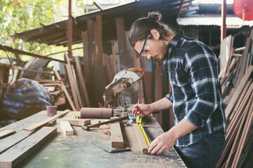Male carpenter working at work. Male joiner doing his job at the carpentry workshop