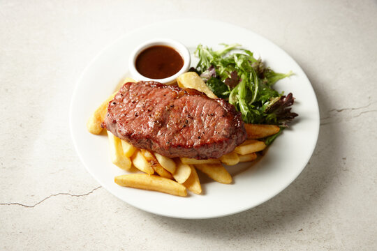 Black angus sirloin steak with fries and salad