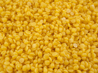 background of yellow pearls of natural beeswax - obrazy, fototapety, plakaty