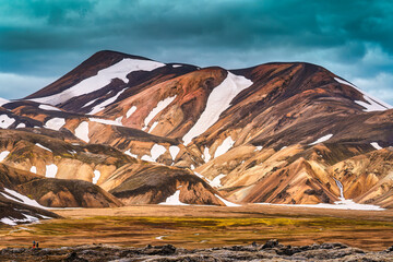 Volcanic mountain with snow covered in summer on Icelandic Highlands at Landmannalaugar