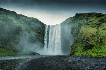 Zelfklevend Fotobehang Powerful Skogafoss waterfall in summer on gloomy day at Iceland © Mumemories