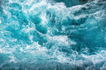 Natural texture crystal blue water rapids sea with air bubbles flowing motion