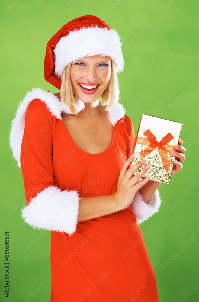 Poster Woman, Christmas and holding gift box in studio holiday giving, festive vacation or smile. Female person, red outfit and portrait for present or excited celebration, winter break on green background