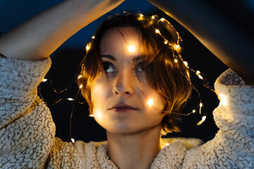 Portrait of a short-haired woman with lights on head