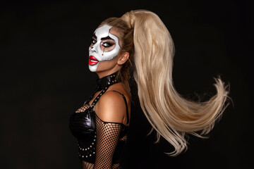 Fototapeta premium Sexy woman in a Halloween makeup on black background.