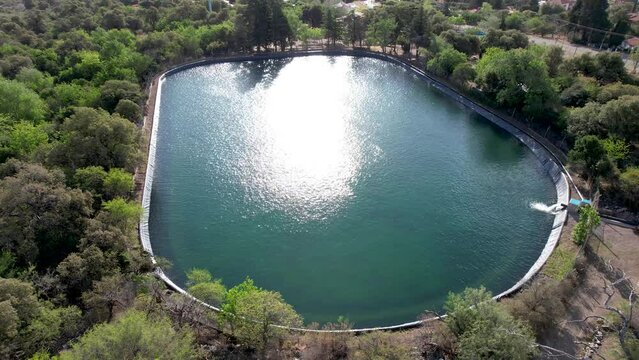 Aerial video of a water tank (pool) for irrigation in agriculture.