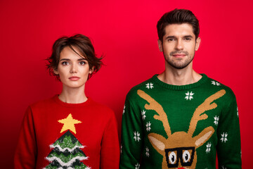 Photo of attractive pretty married couple wear ornament sweaters isolated red color background