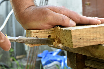 The moment of a carpenter working with wood.