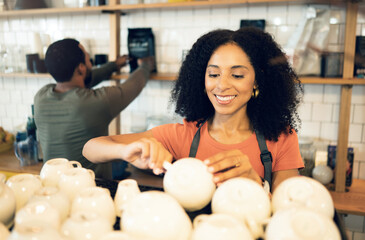 Barista woman, coffee shop and cleaning cup with smile, packing and organized at small business,...