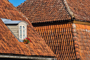 Old, historical red tiled roof and window, Kuldiga, Latvia.