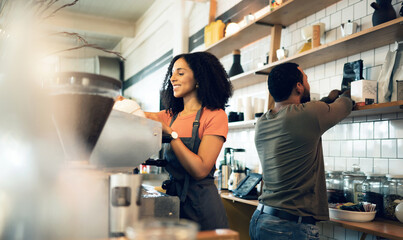 Happy woman, barista and coffee at cafe for service, beverage or preparation by counter at store. Female person, team or waiter making espresso, cappuccino or latte at restaurant or retail shop