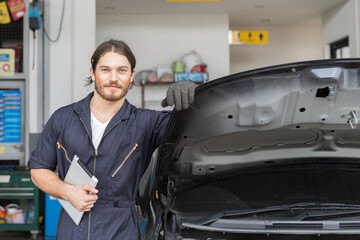 Portrait of male car mechanic worker working in garage. Male technician at auto car repair service shop. Maintenance concept