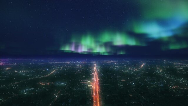 Aerial view of huge city at night time. Aurora light effect at the sky. Fantastic and epic cityscape.