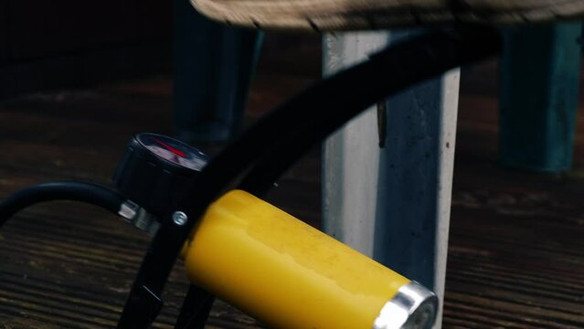 Foot using manual tire pump 