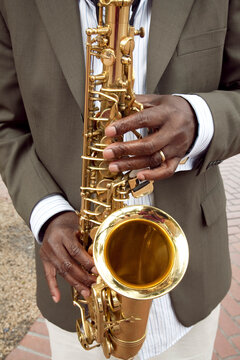 Close up of hands playing the saxophone