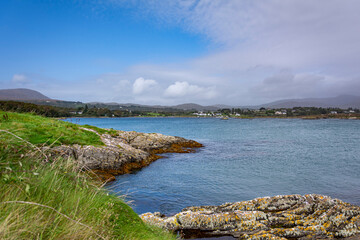 Rocky shoreline with blue atlantic waves on a sunny day with blue sky