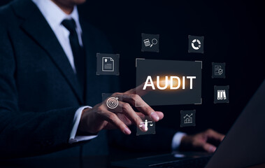 Audit concept with icons, Businessman working with computer and touching on word audit on virtual...