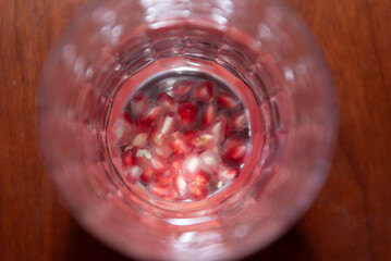 glass of water with pomegranate seeds