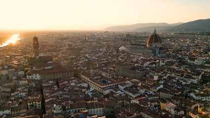 Establishing aerial view shot of Florence city skyline, sunset golden hour, historic city center, Cathedral of Saint Mary of the Flower, Italy