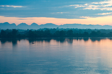 beautiful scenery The sun rises over the mountains in the early morning. In the foreground is the Mekong River, the border point for Thailand and Laos.