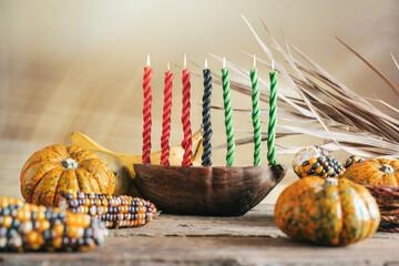 Kwanzaa, african holiday Kwanzaa with decoration of seven candles in red, black and green colors,...