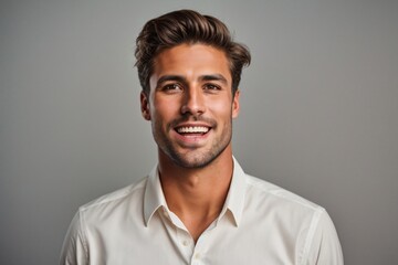 a photo of a handsome young male smiling dealer on a solid grey background. Generative Ai.