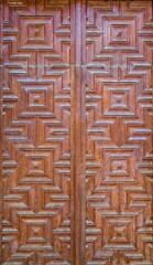 Old ornate wooden door with beautiful carvings.