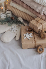 Christmas gifts wrapped in craft paper with twine and snowflake on white background