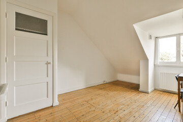 an empty room with wood flooring and white walls in the room is very light, but it's not clear