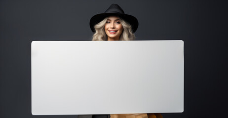 Beautiful smilling woman holds empty white blank frame. Autumn discount and sale concept. business marketing or brand promotion. Advertising banner