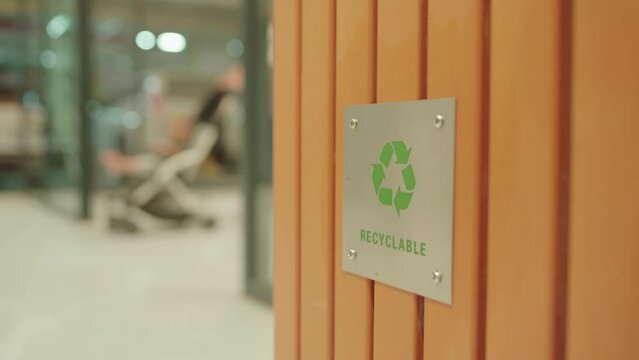 Garbage bins trash can with recycle logo at the entrance to the shopping center. Symbol of recycling, waste sorting and saving the environment 4K