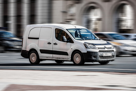 Van car Citroen Berlingo Second generation B9 drive on the city road. Fast moving white commercial auto